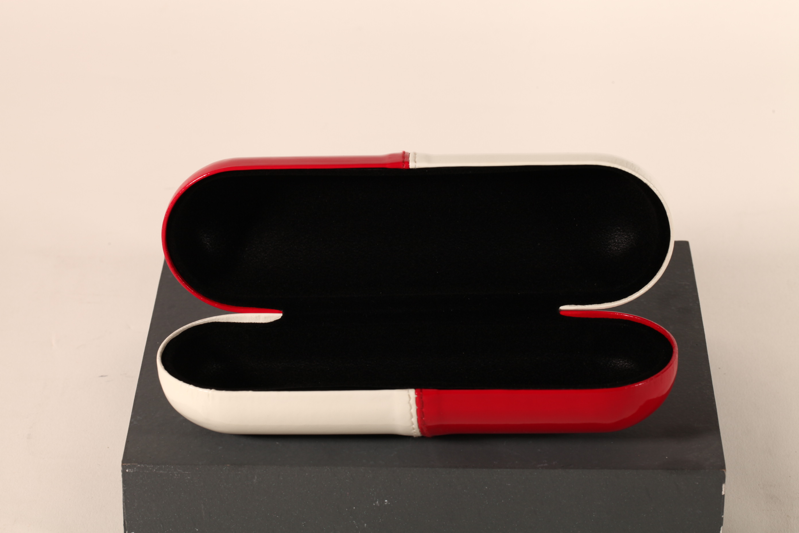 A pill-like eyeglasses case printed with CONAN LOGO, with a novel design, small and cute