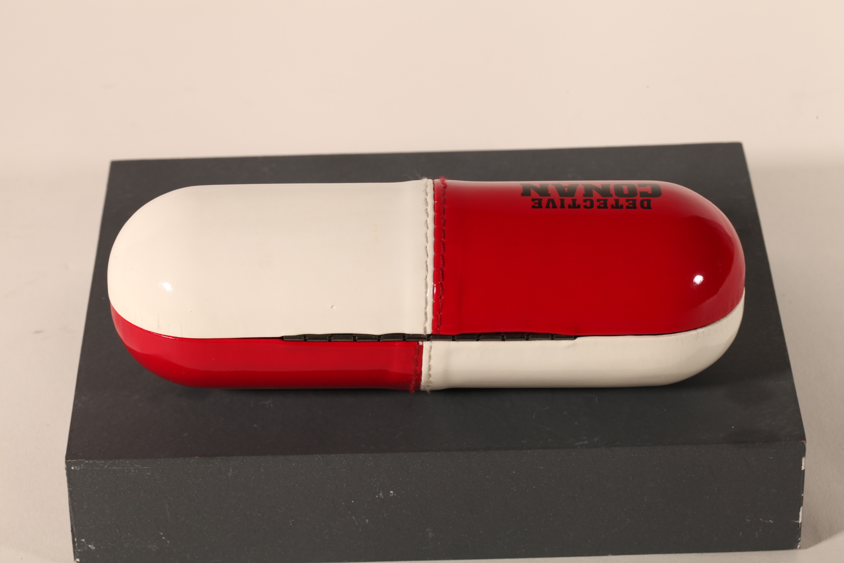 A pill-like eyeglasses case printed with CONAN LOGO, with a novel design, small and cute