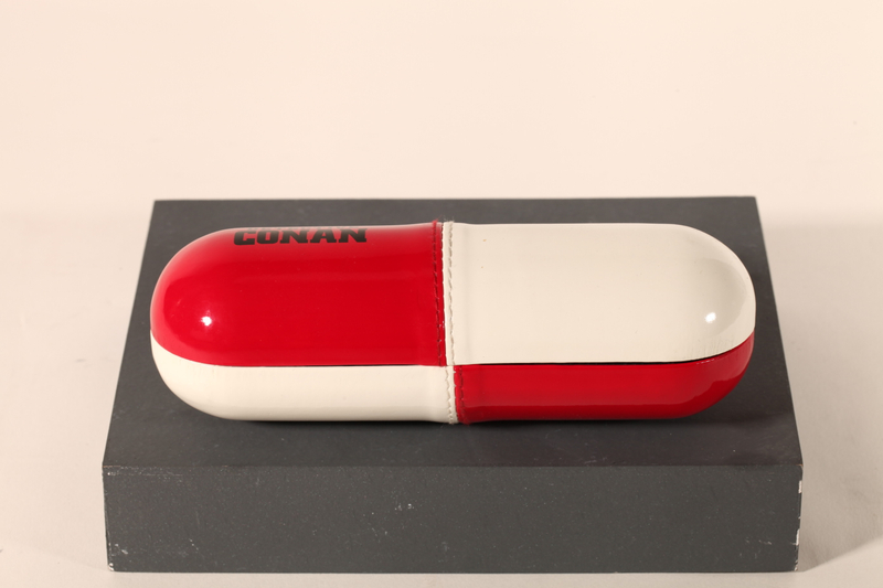 A pill-like eyeglasses case printed with CONAN LOGO, with a novel design, small and cute