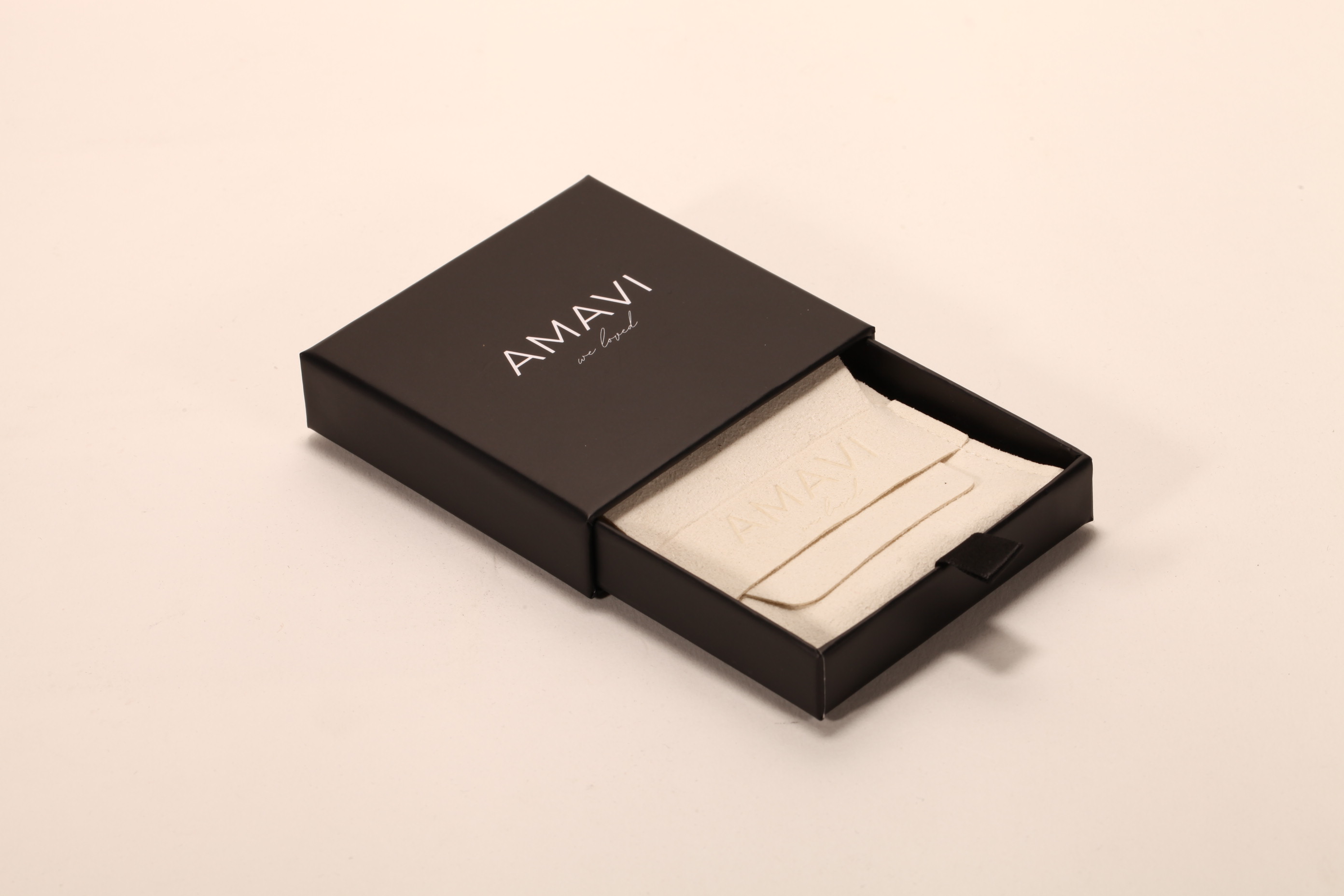 A small black pull-out carton set with leather soft bags