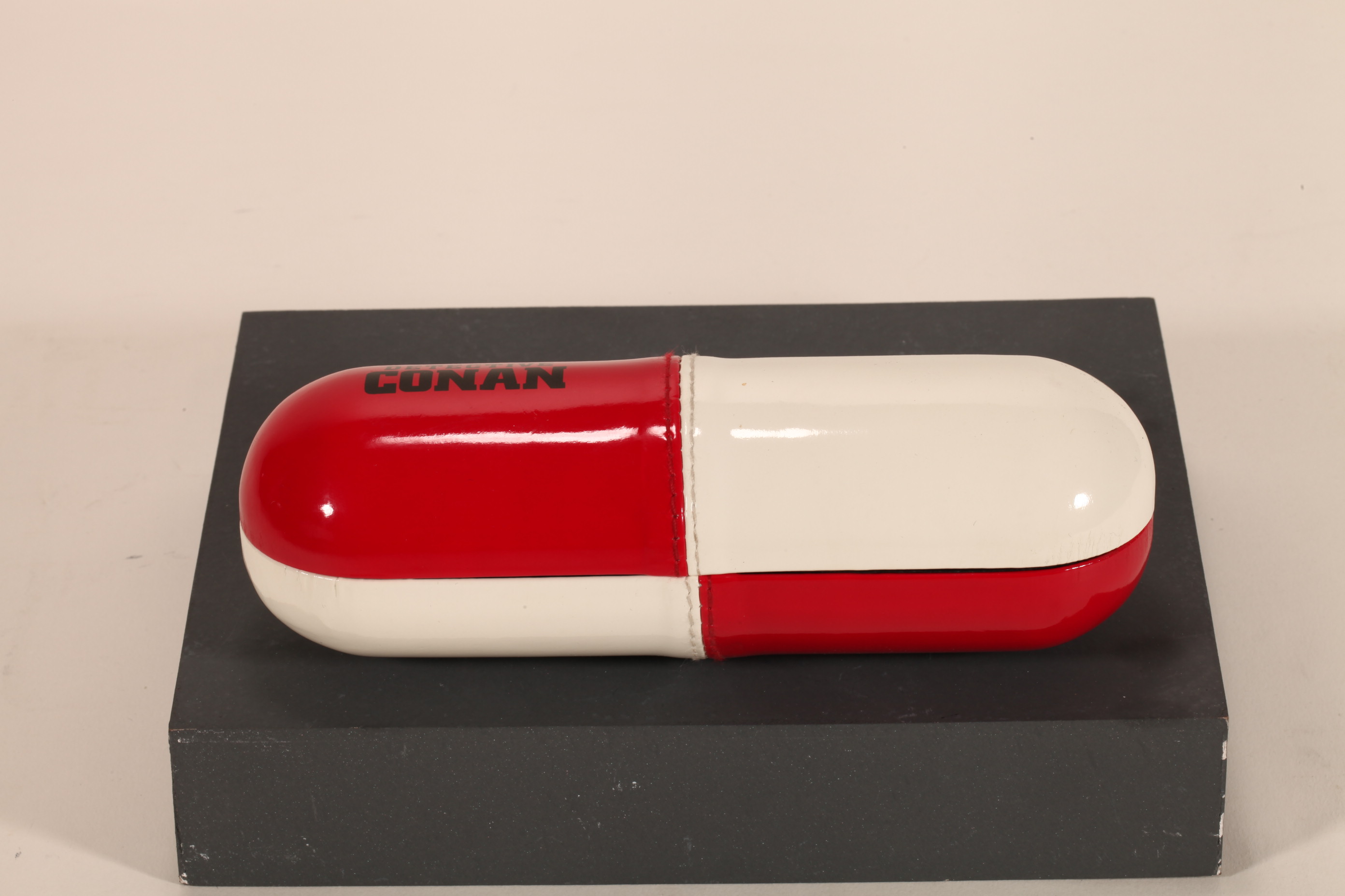 A pill-like eyeglasses case printed with CONAN LOGO, with a novel design, small and cute