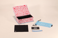 This eyewear case set includes a red and white patterned box, a blue pouch, and other accessories.