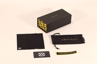 This eyewear case set includes a black box with yellow pattern, a pouch, cloth and tags.