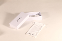 This EVRY eyewear set includes a sleek white rectangular paper box and a matching drawstring pouch. Both feature the black "EVRY" logo. The minimalist, modern packaging is clean and stylish.