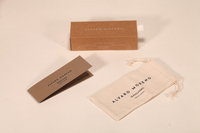 Here's a 30-word English description for the eyewear set shown in the image: This Alvaro Moreno eyewear set includes a navy paper box and a matching foldable case. Compact at 15.5×6×4 cm. Elegant and