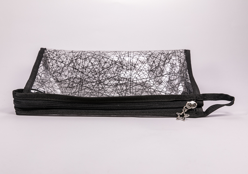 The grayish black, heavily striped, zip-and-zip bag of 2021 will hold gadgets and toiletries