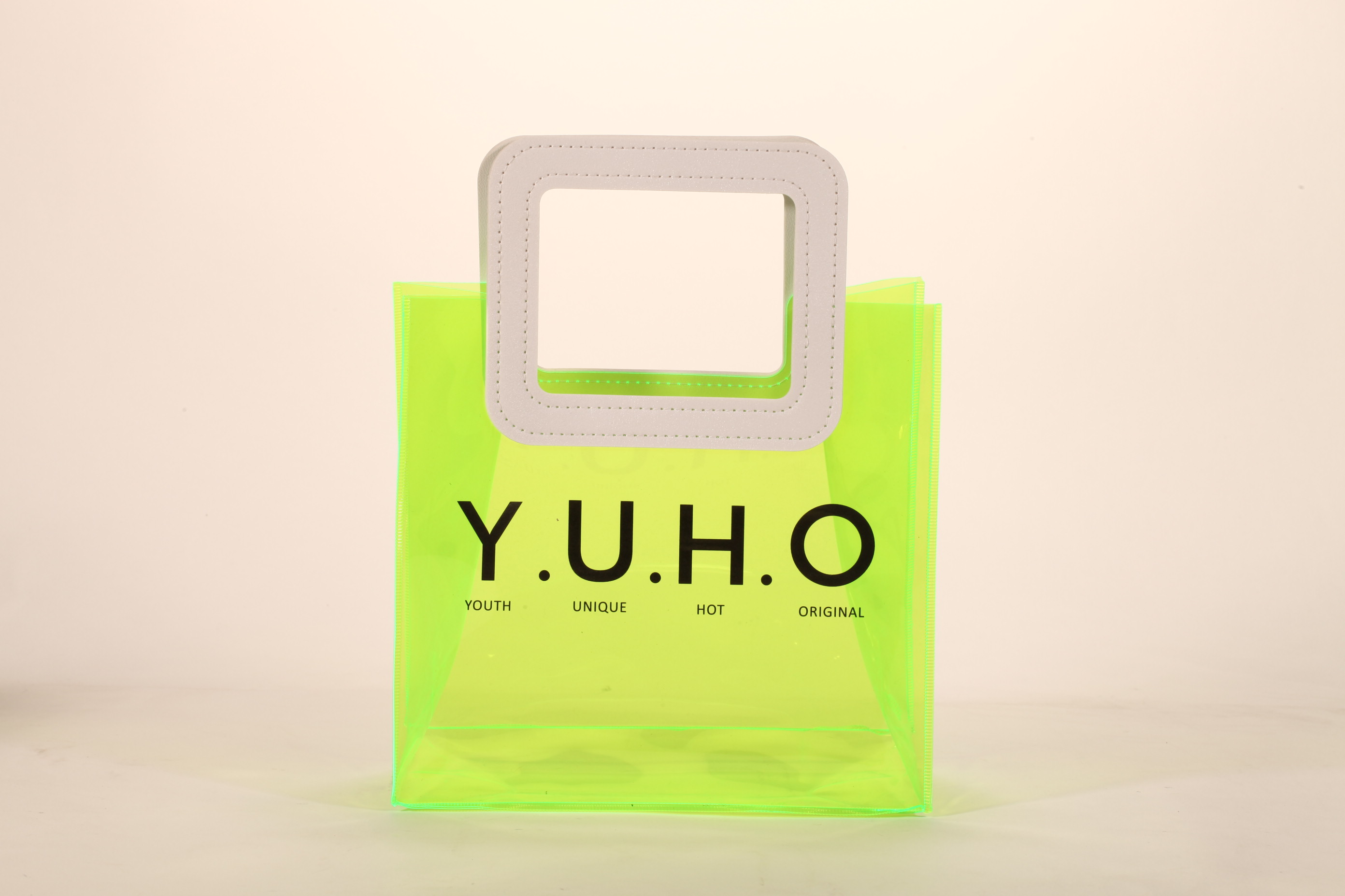 Three translucent bags in green, pink, and blue feature white square handles. The front displays the black text "MARMOTT EYEWEAR".